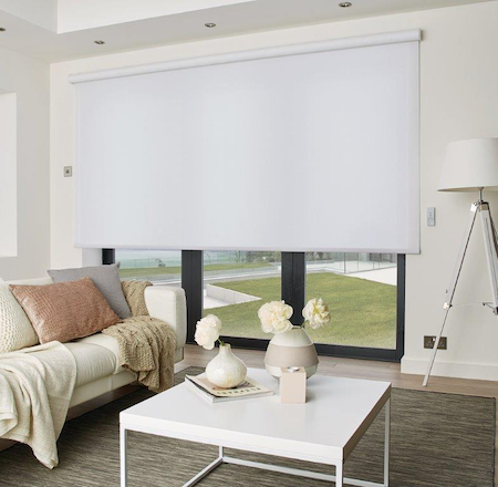 sheer roller blind over bifold doors in a homes lounge area