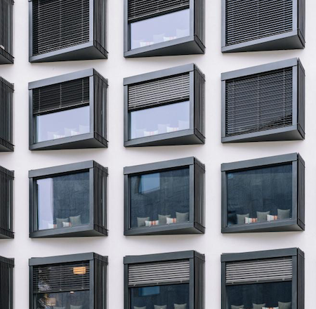 view of the exterior of an apartment building using pvc blinds